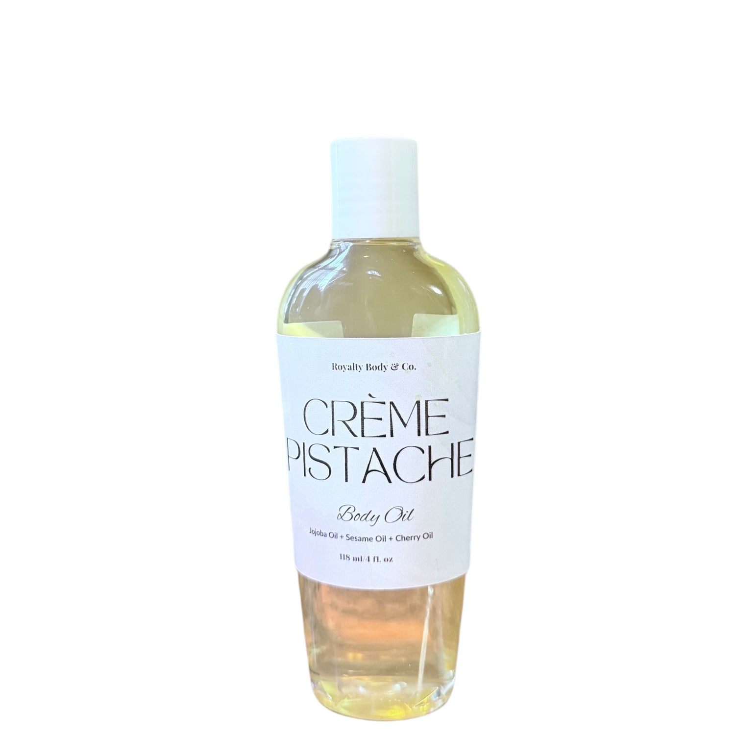 The clear bottle of Whipped Pistachio Crème Body Oil by Royally Body & Co. blends apricot, sesame, and cherry oils for intense hydration. The light yellow oil offers a lasting fragrance and comes with a white cap, containing 11 fl oz of nourishing luxury.